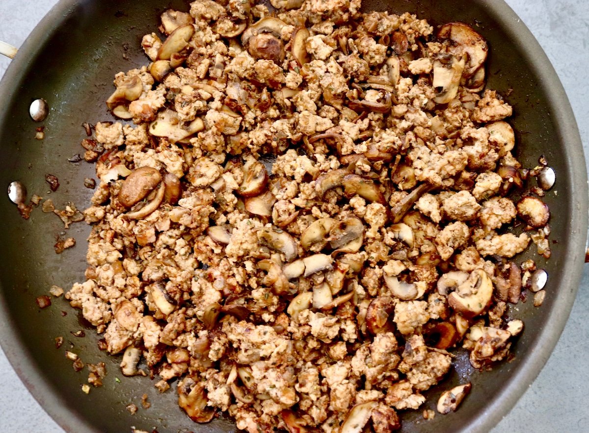 Baked pork with onions and mushrooms in a skillet.