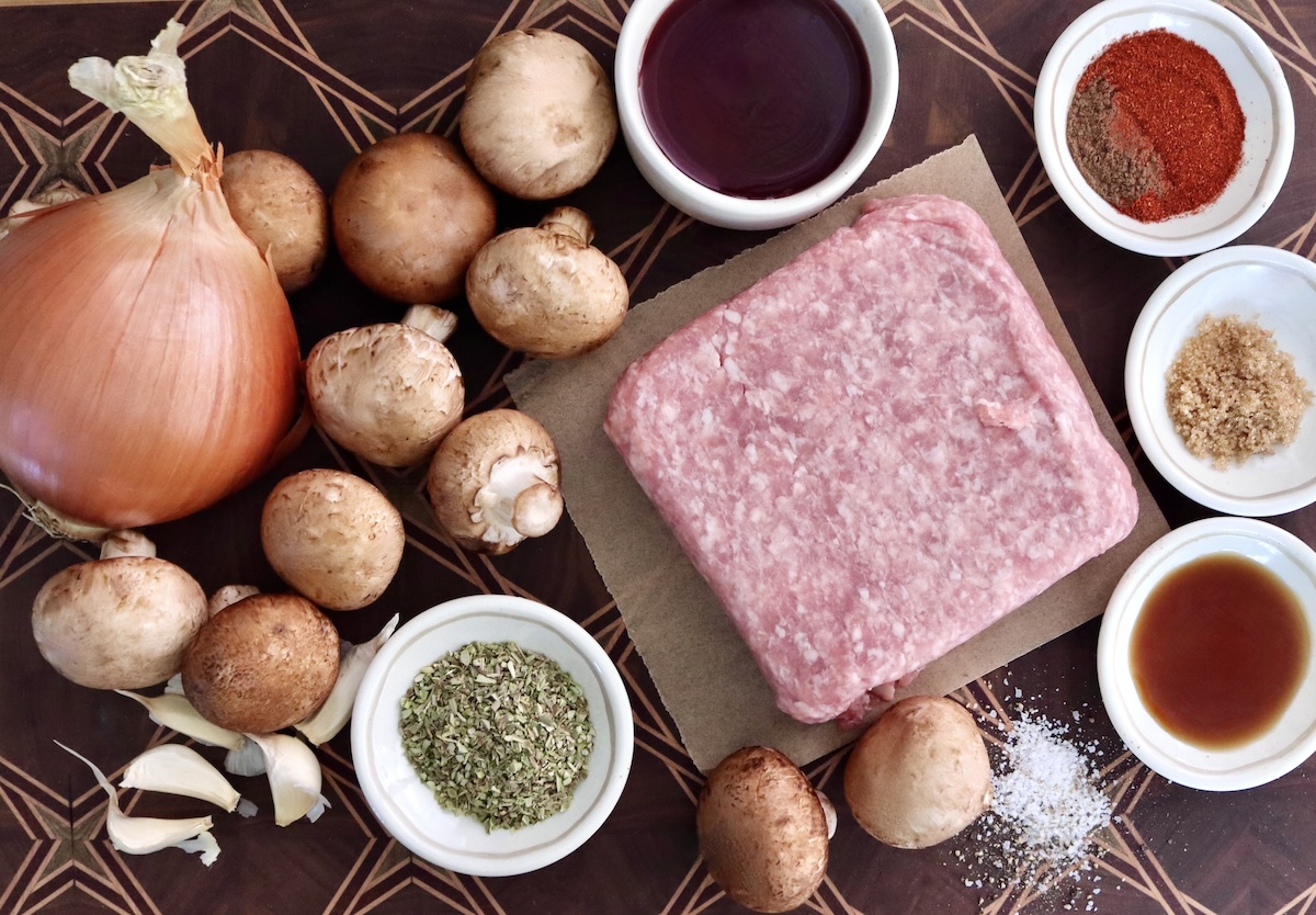 Ingredients for Portuguese sausage include raw ground pork, mushrooms, onions, garlic, oregano, smoked water, red wine and paprika.