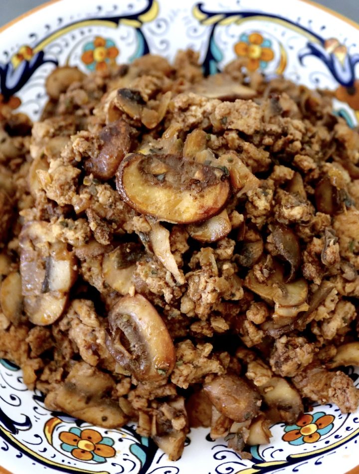 Italian painted bowl filled with deconstructed Portuguese sausage.