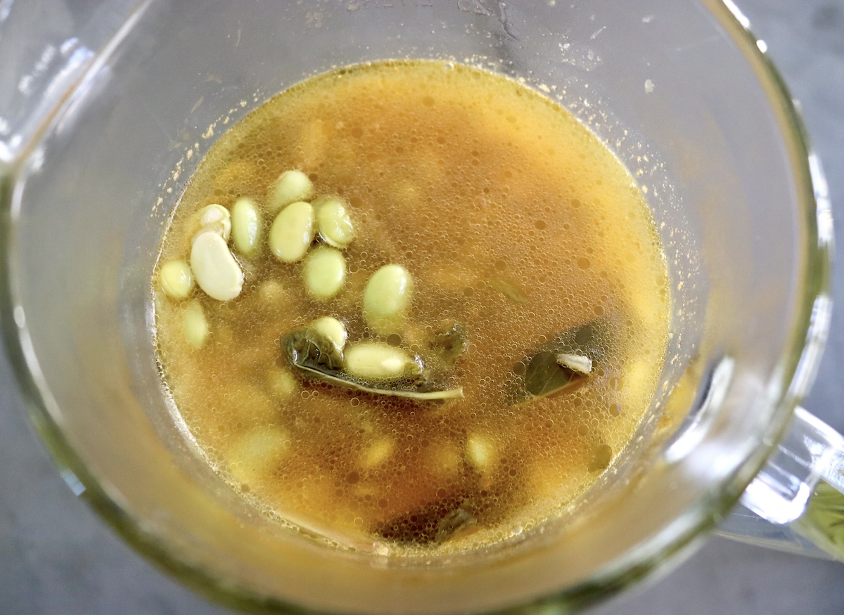 Top vie of the blender with the cooked edamame soup before blending.