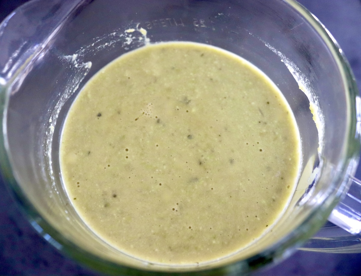 Top vie of blender with boiled and pureed edamame soup.