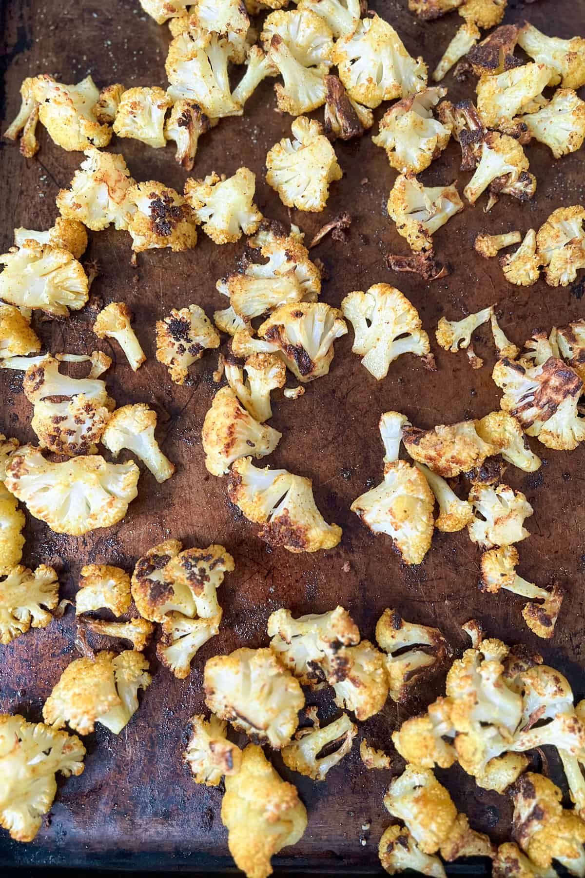 Roast cauliflower on a rimmed baking sheet.