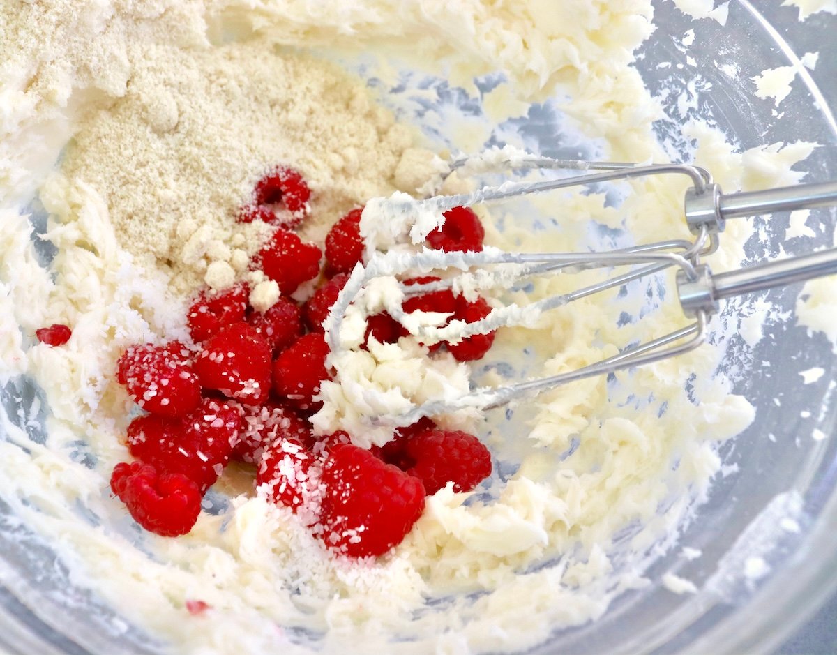 Mix the flour and sugar in a glass bowl with fresh raspberries on top, and two pulses from an electric mixer.