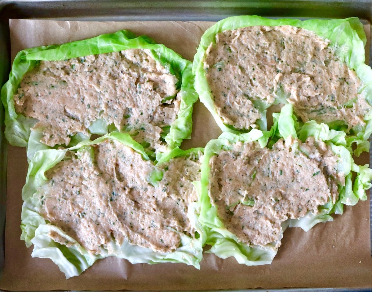 Four cabbage leaves spread with salmon mousse.
