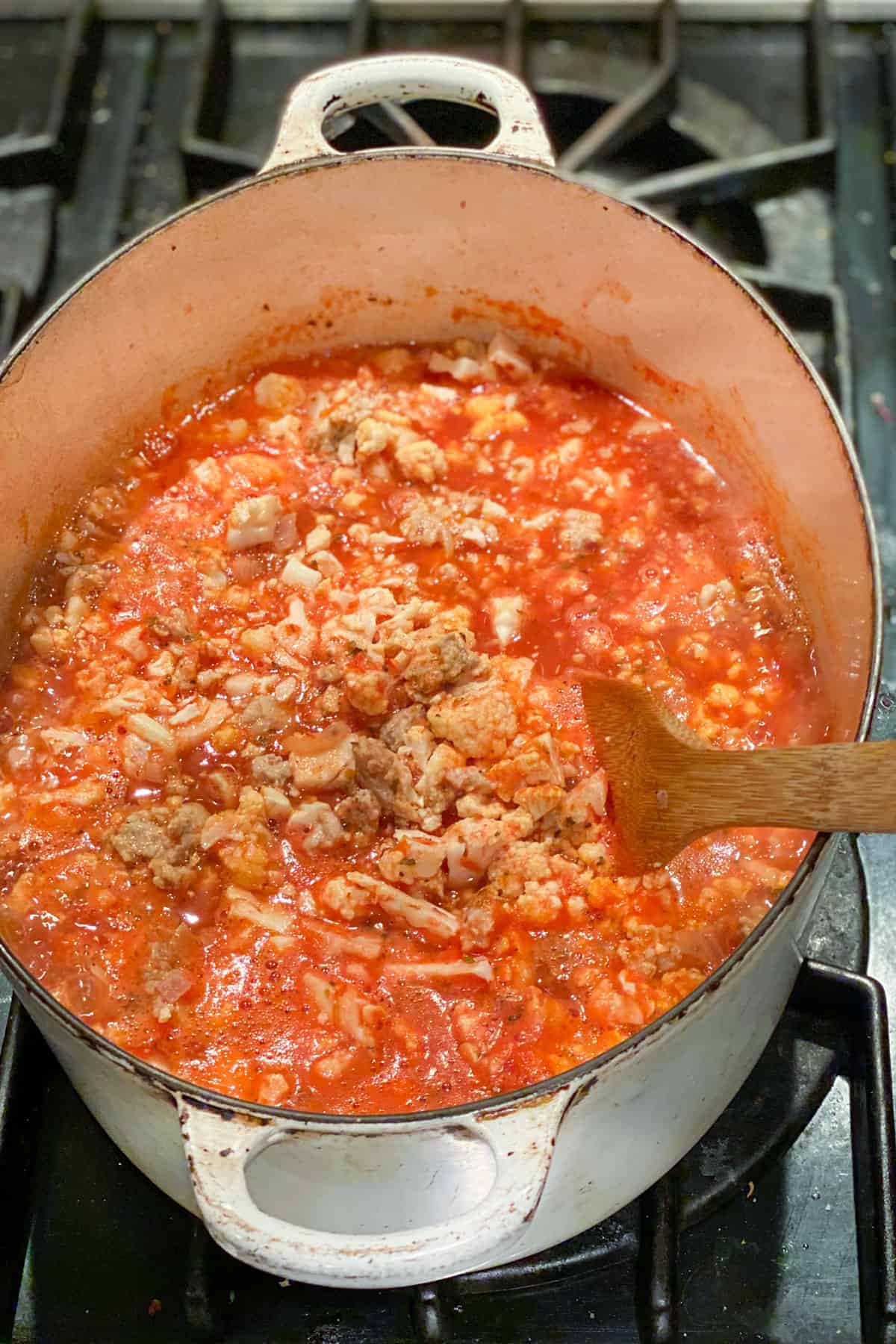 chunky ground turkey soup tomato sauce in a dutch oven.