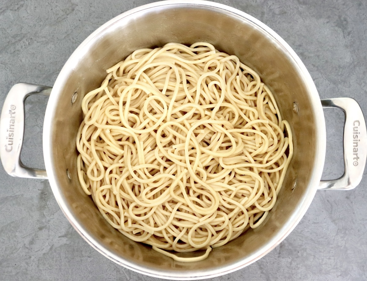 A large pot of cooked Chinese noodles.