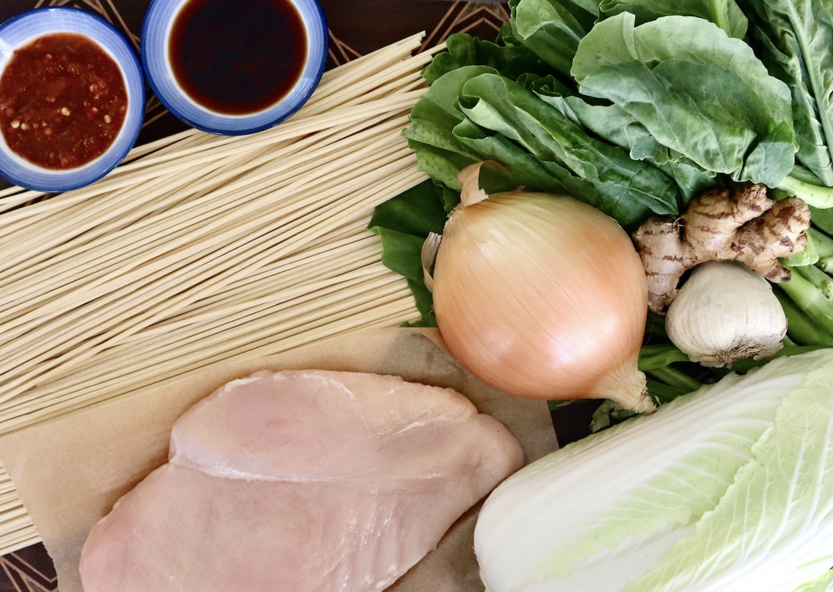 Ingredients for Longevity Noodle Stir Fry include chicken breast, onion, Napa cabbage, ginger root, garlic, dry Chinese noodles, Gai Lan soy sauce and chili paste.