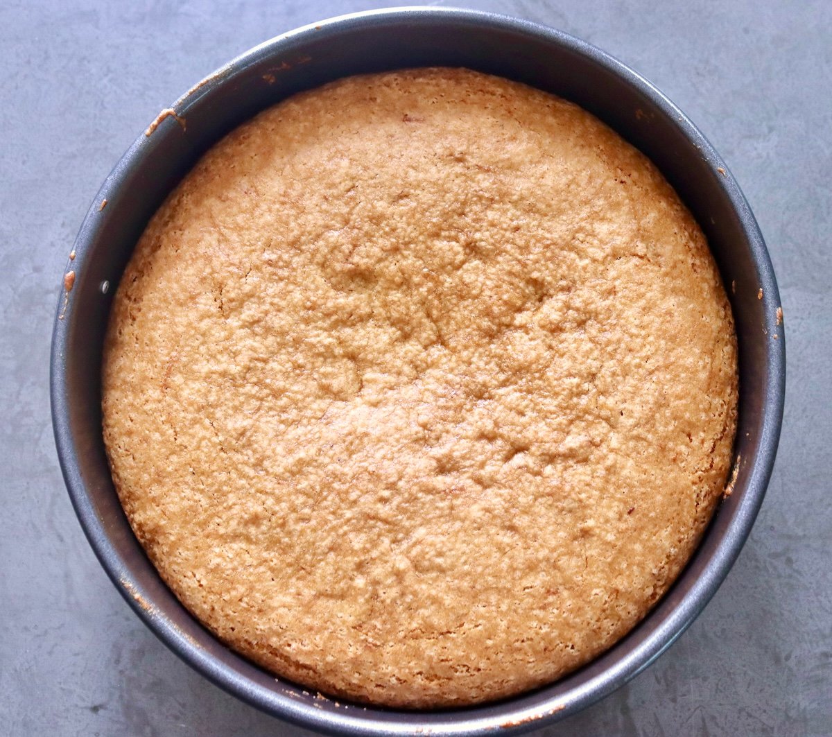 Baked golden lemon cake in a cake pan.