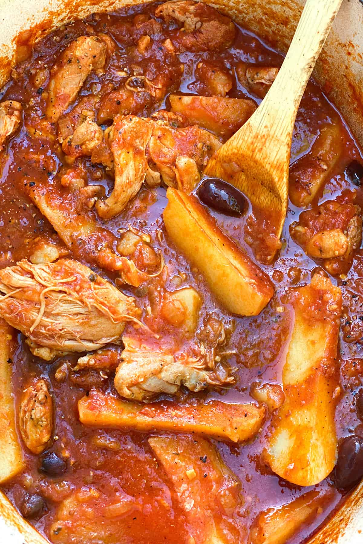 tender boneless chicken thighs and potato wedges in tomato sauce and black olives