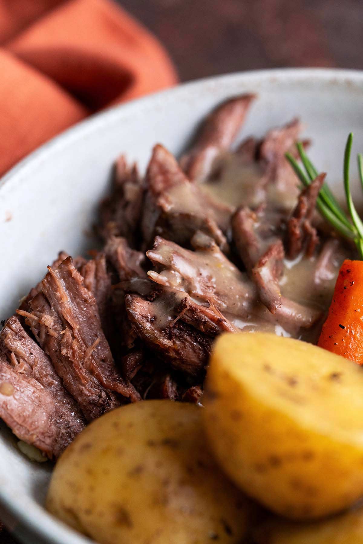 close up of tender beef chuck roast cooked in dutch oven