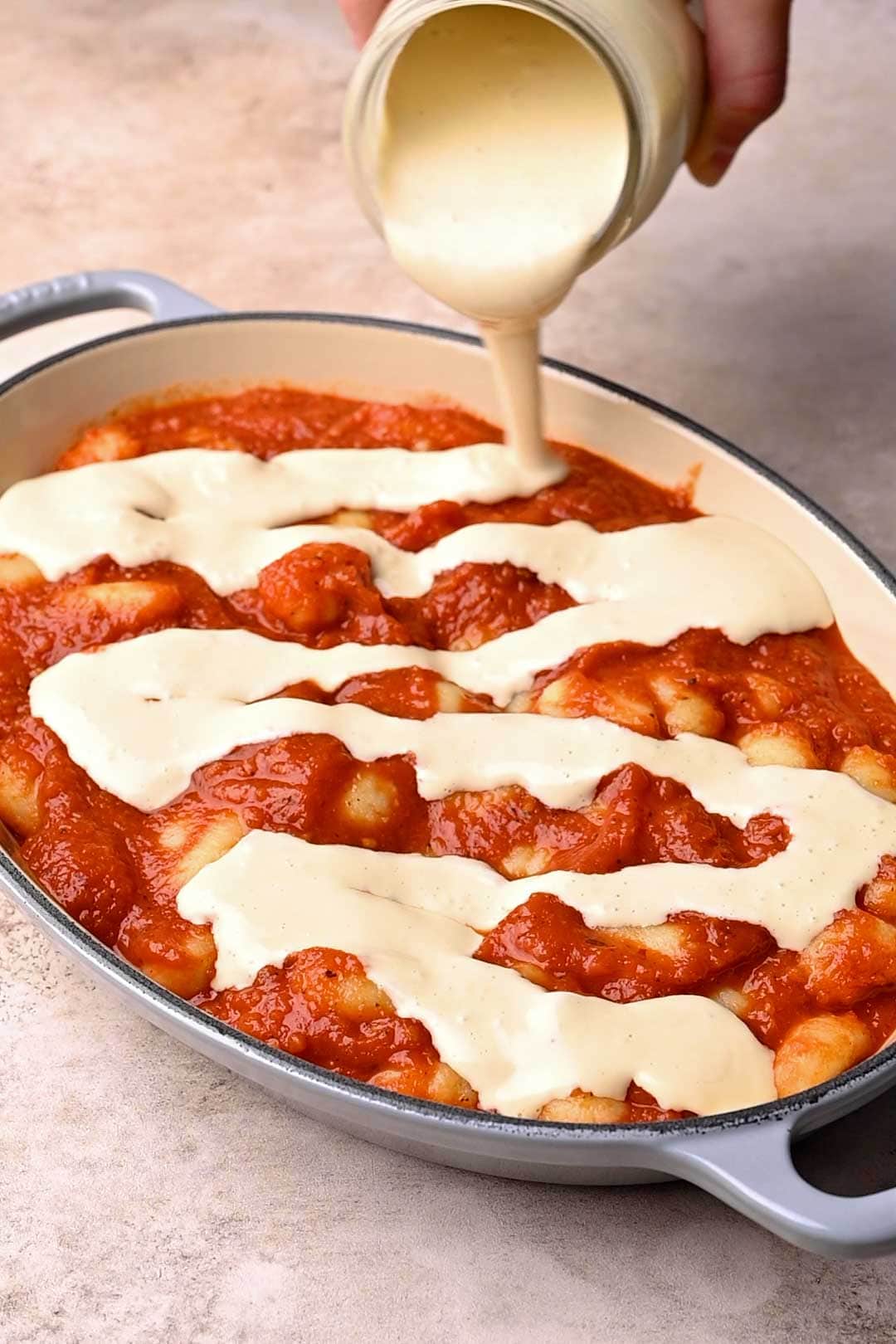 pour the mozzarella sauce over the gnocchi