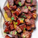Steak Bites on a plate with a spoon