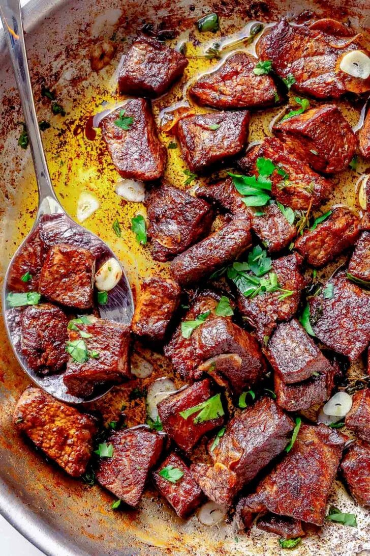 Steak Bites in skillet with butter, garlic, and thyme