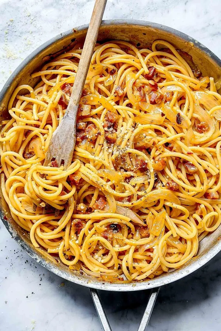 Chili Crisp Carbonara in a skillet with a fork