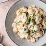 vegan creamy garlic noodles garnished with minced parsley