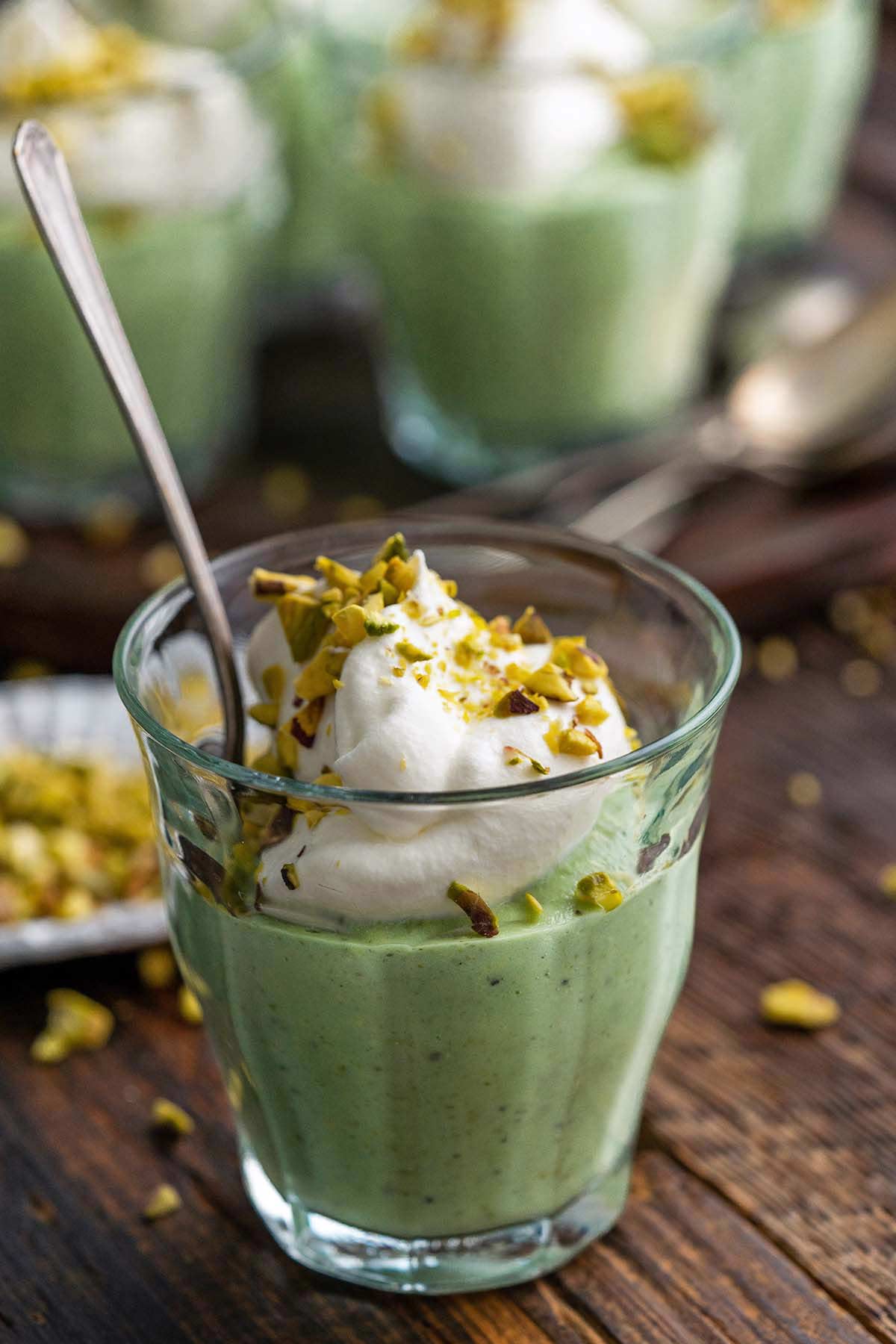 pistachio pudding with whipped cream in glasses