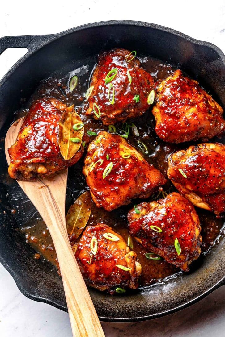 Filipino Chicken Adobo recipe in a skillet with a spoon