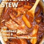 The oval of the dutch oven is filled with falling tender chicken thighs and potato wedges in a tomato sauce with kalamata olives - a wooden spoon brings out the rest.
