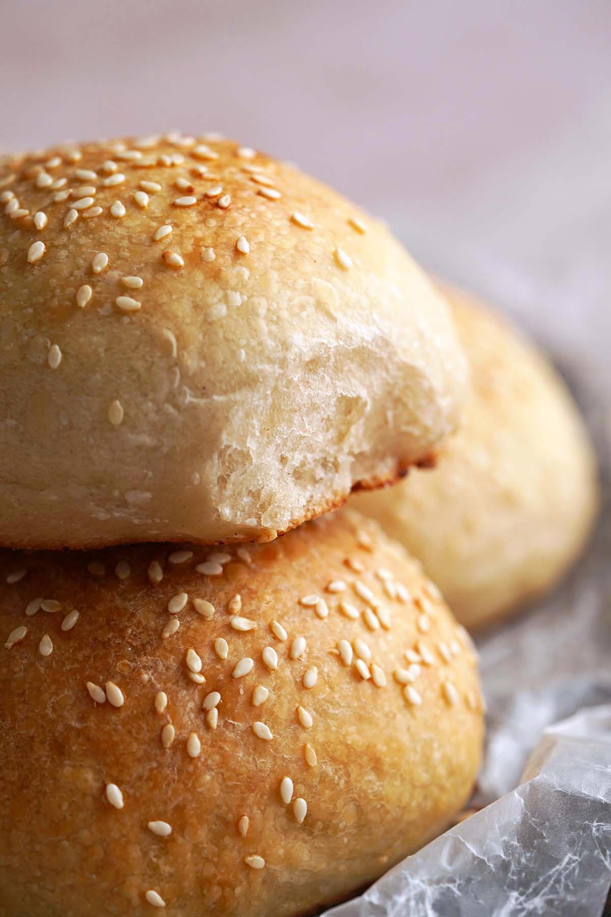 close up of seeded sourdough rolls showing fluffy interior texture
