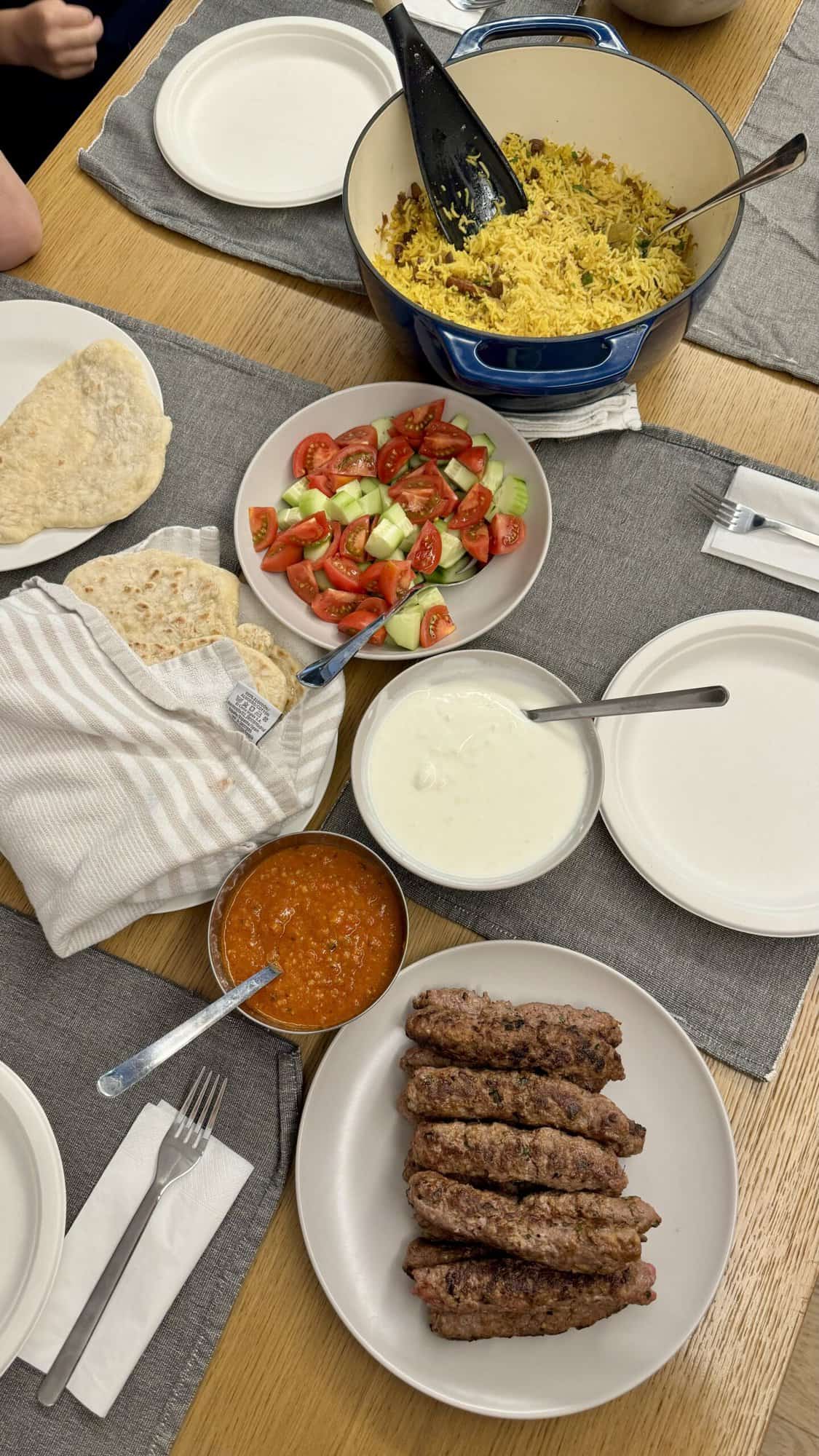 A delicious dinner of yogurtlu kebabs is perfect for sharing pita with all the sauces.