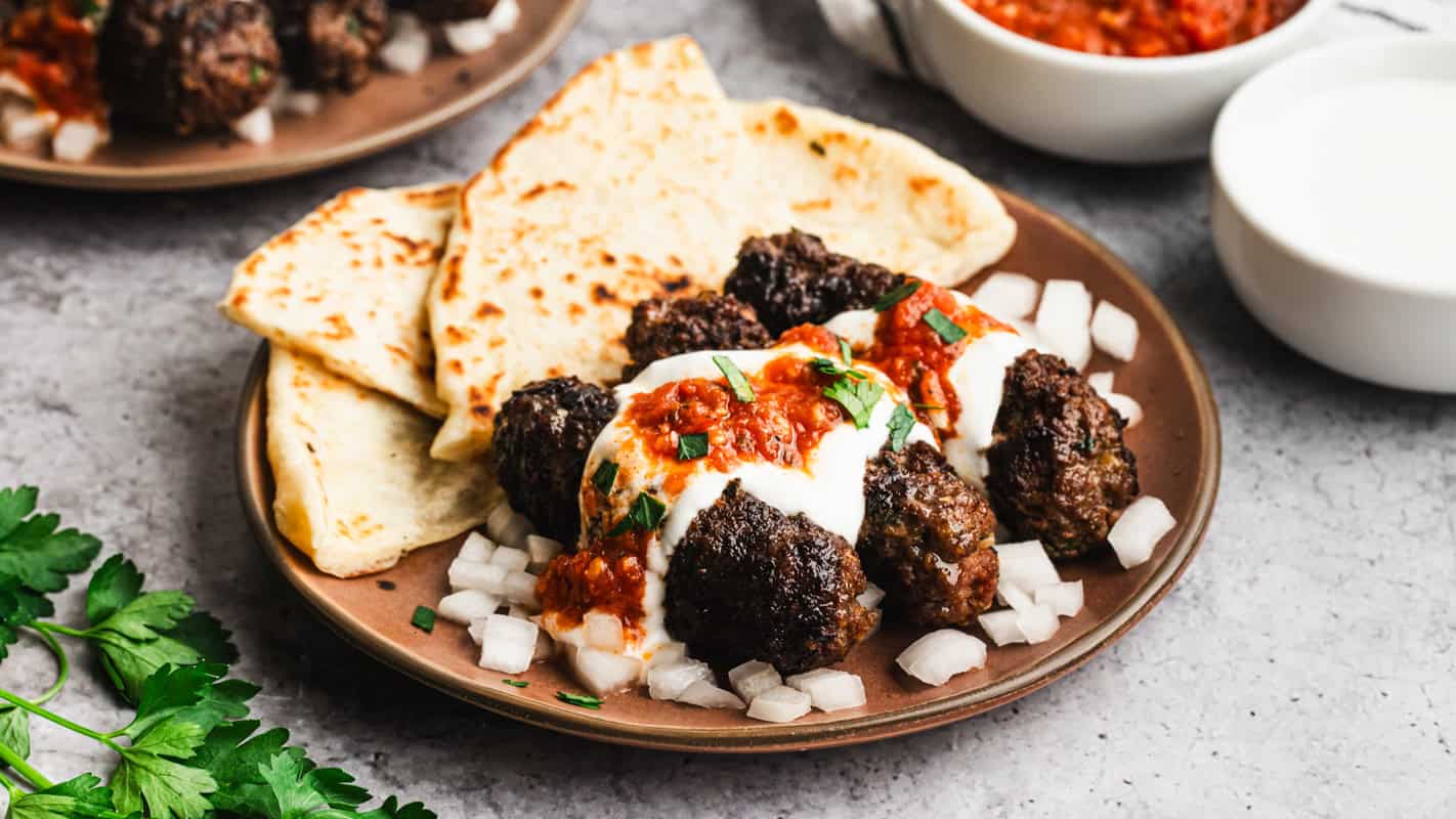 These Yogurtlu Kebabs turn ground beef into something special with a creamy yogurt sauce and a warm spicy tomato sauce.